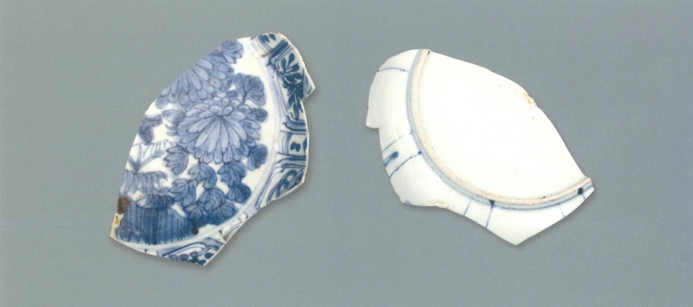 【青花瓷器】澳門出土的青花花卉紋盤(殘)
Blue-and-white dish with flower design (Shard)
萬曆晚期(Late Wanli)
足徑(FD) 14.2cm
胎質緻密細白，釉泛青。青花發色鮮豔，藍中微泛青紫。紋樣佈滿整個青花盤，盤心為盛開的菊花，內壁如意形開光內分別飾雜寶和花卉。這些開光之間還隔著小開光。青花混水塗抹，發色較淡雅。
